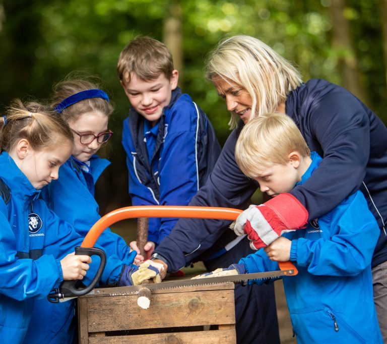students cutting wood together