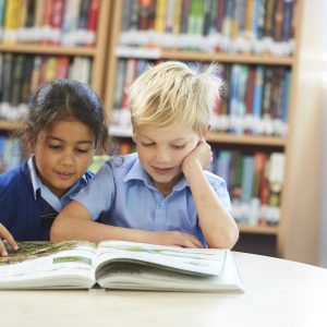 2 students reading a book