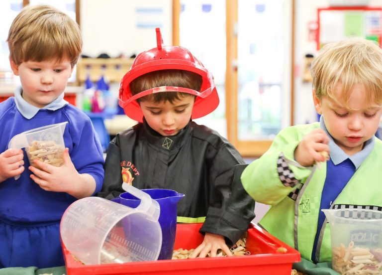 nursery students playing with pasta