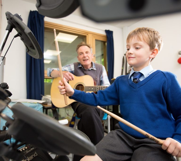 student learning the drums