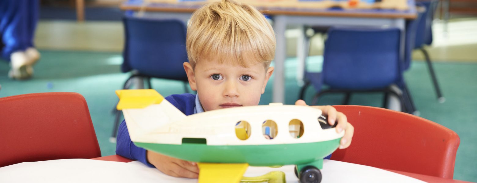 Boy holding a plastic aeroplane