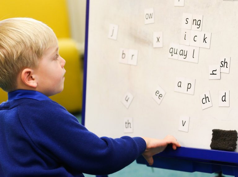 student practicing letters