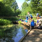 children and parents exploring the pond wildlife
