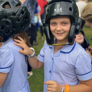 2 girls wearing safety helmets