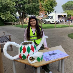 girl standing by a sign