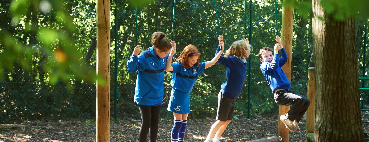 students playing in the forest
