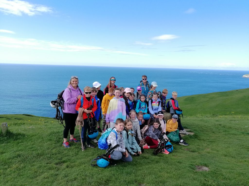 students by the mountains of the cliff