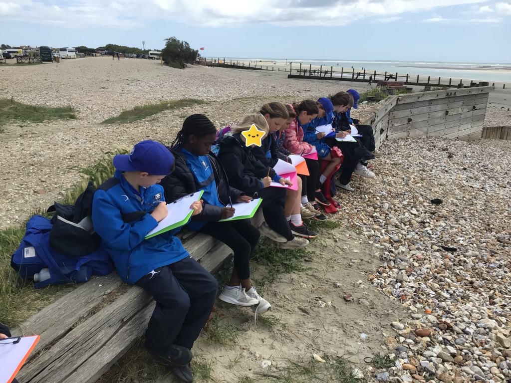 Students writing onto clipboards