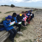 Students writing onto clipboards