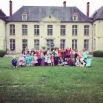 Students outside a large manor building