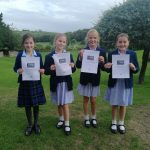 students holding up certificates