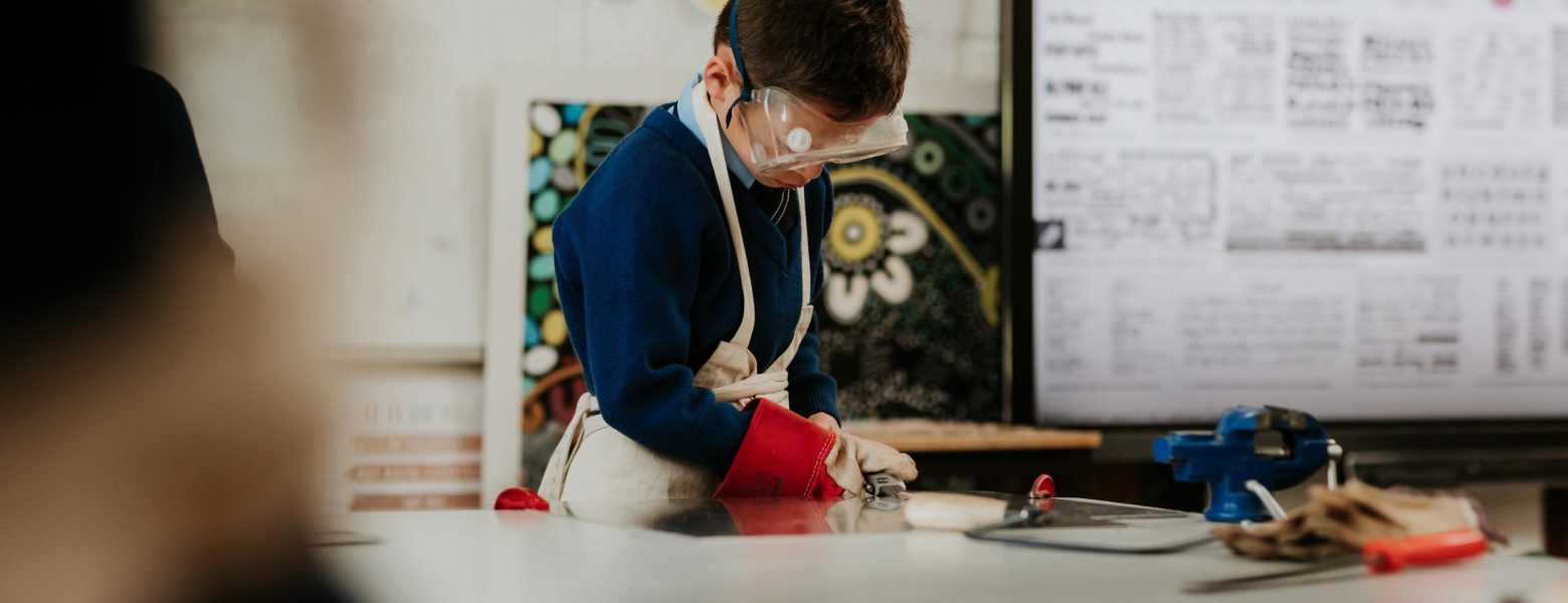 student working on a woodwork model