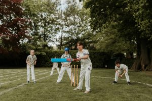 students playing cricket