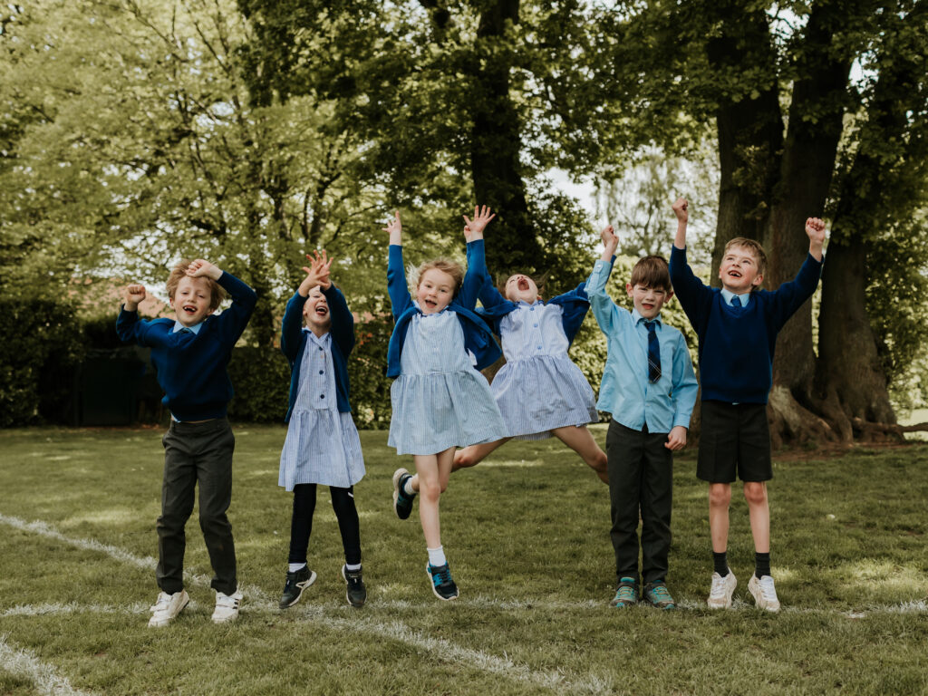students jumping for a photo