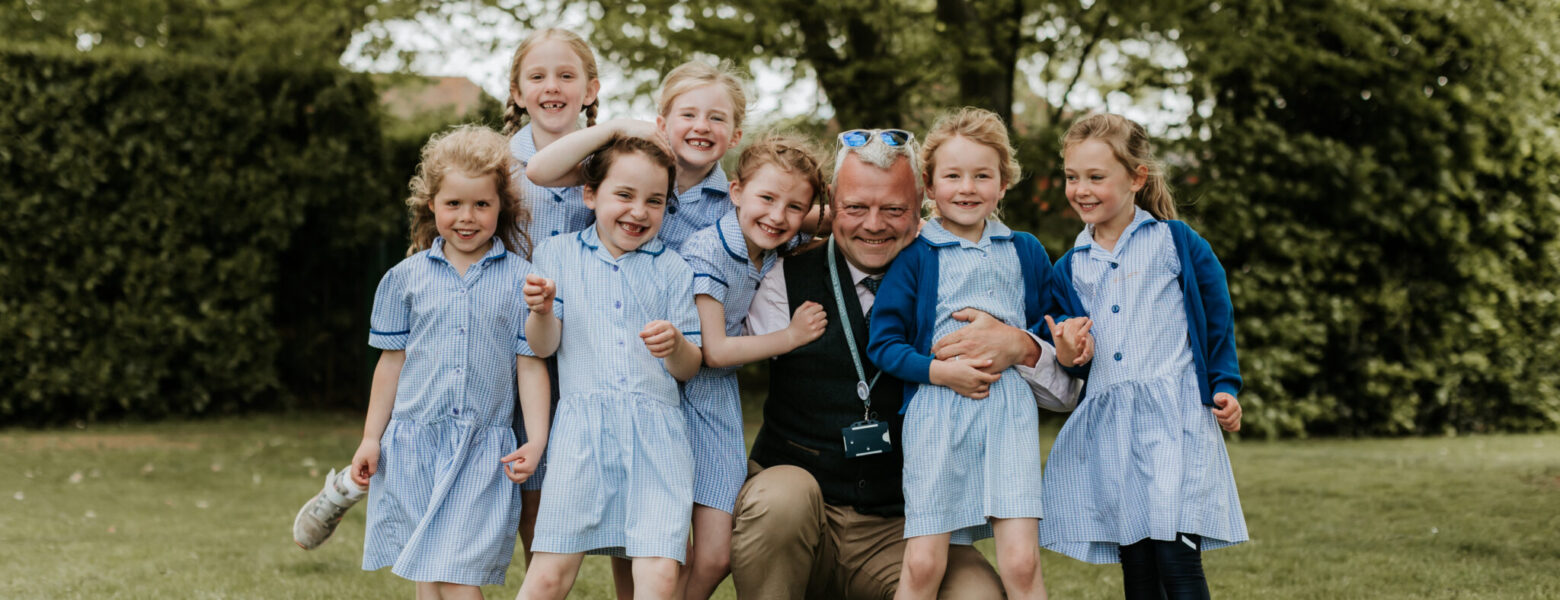 headteacher surrounded by his students