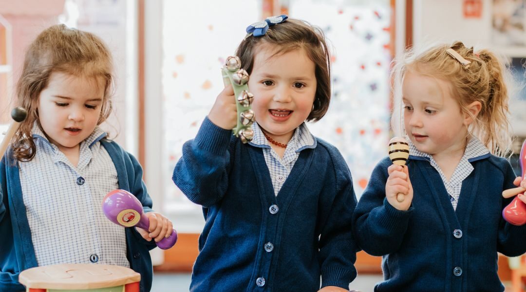 nursery students playing musical instruments