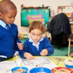 Two Reception aged children at school taking part in active learning