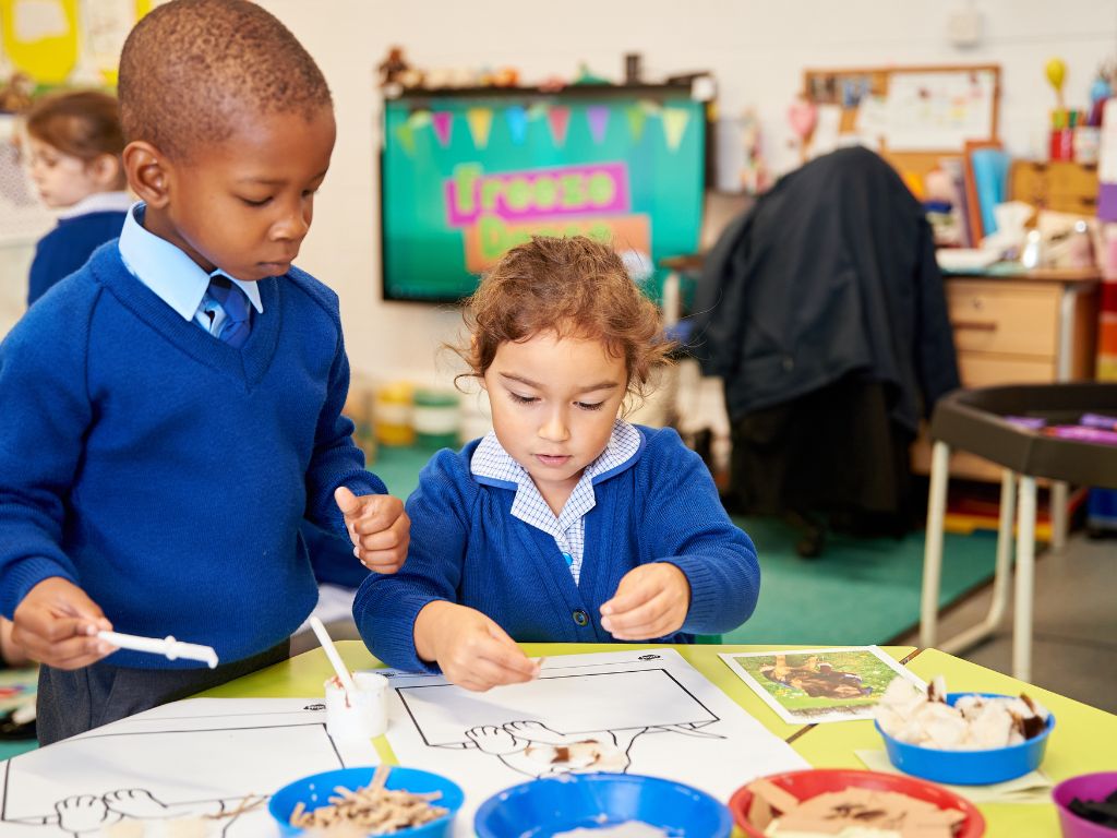 Two Reception aged children at school taking part in active learning