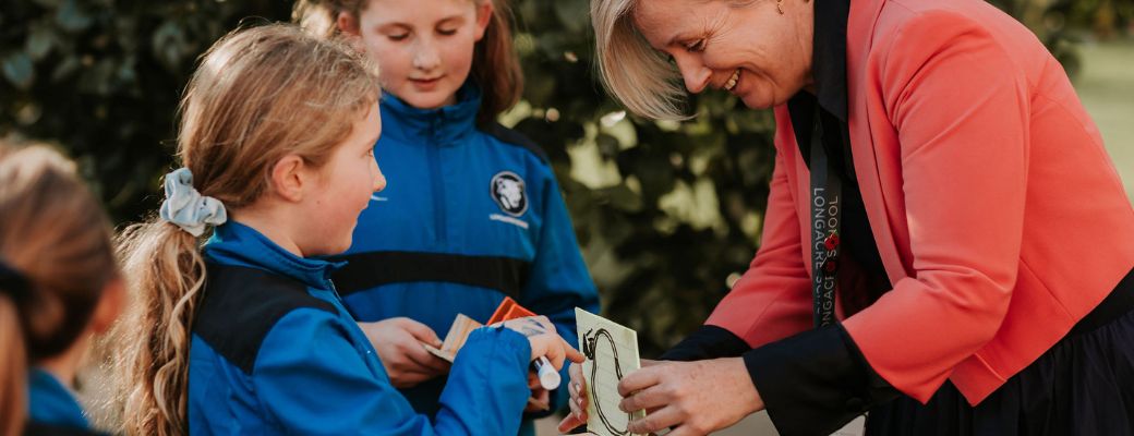 Teacher and student outdoors, working on DT project