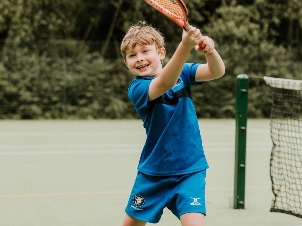 Young boy playing tennis at Longacre School